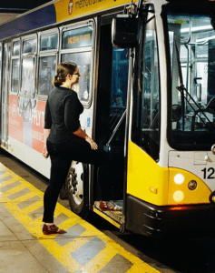 Woman Walking Onto Bus